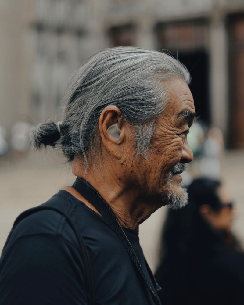 Elderly person wearing a hearing aid