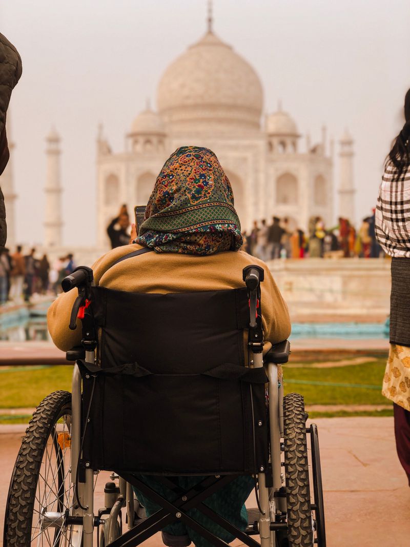 Person in a wheelchair visiting the Taj Mahal, India